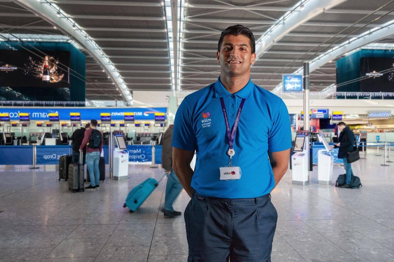 Mitie cleaning colleague standing in a UK airport terminal